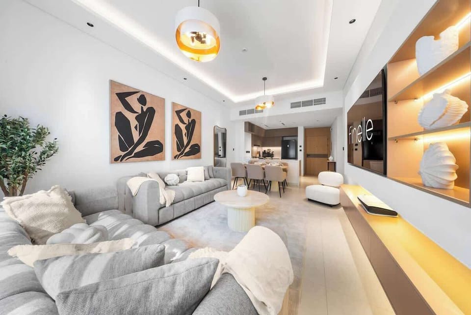 Stylish living area with seating, Smart TV, and balcony views