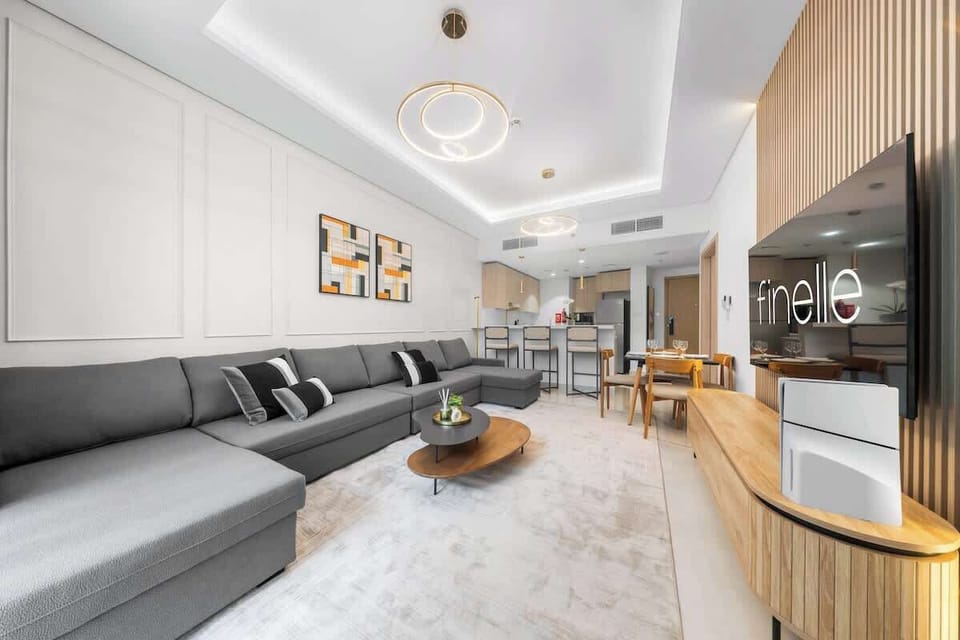 Step into spacious living room with sleek modern style and a flat-screen TV, perfect for relaxing or entertaining in comfort.