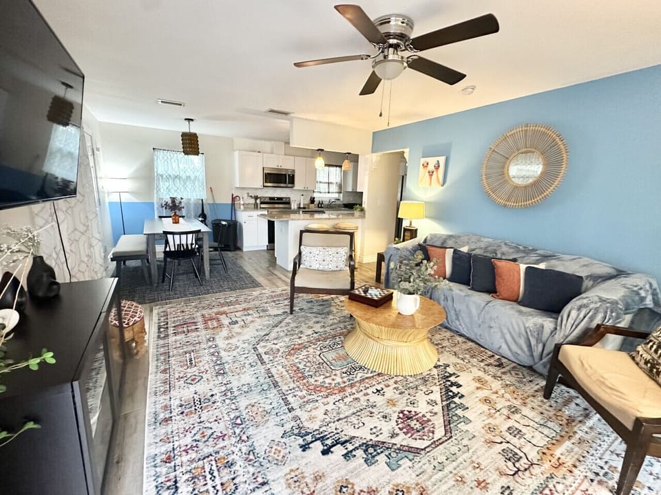 Unwind in the expansive living room, featuring a seamless open floor plan that flows into the kitchen/dining area.
