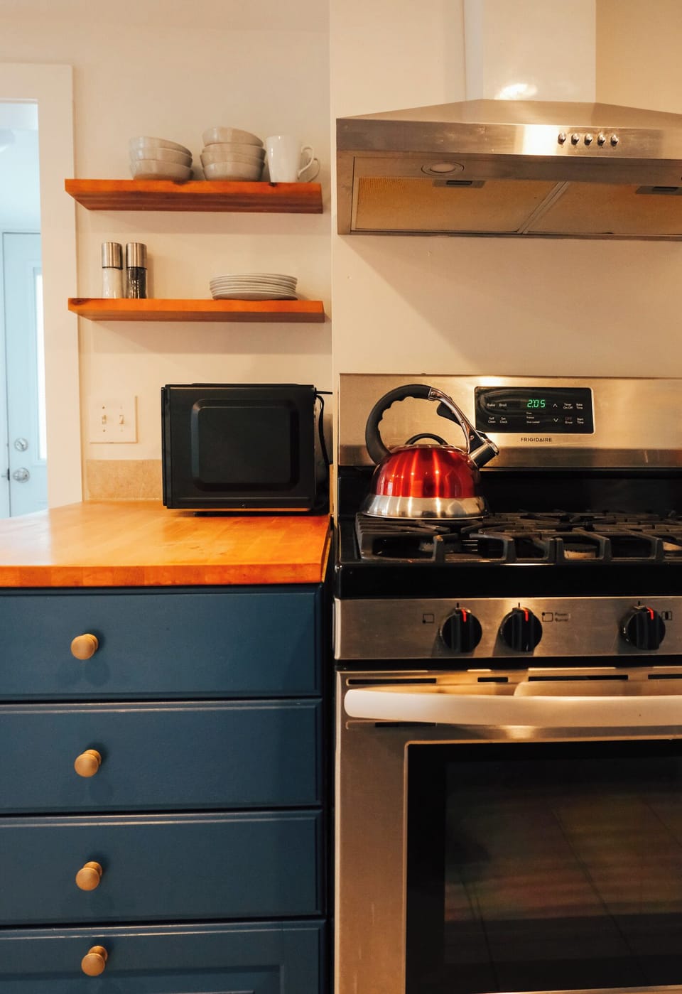 Fully equipped kitchen featuring modern appliances and a gas range.