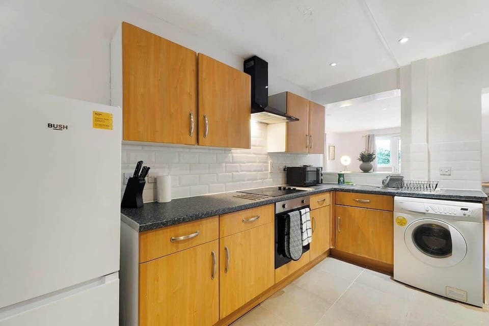 Kitchen equipped with all essentials, including a dryer, oven, fridge and full cookware set.