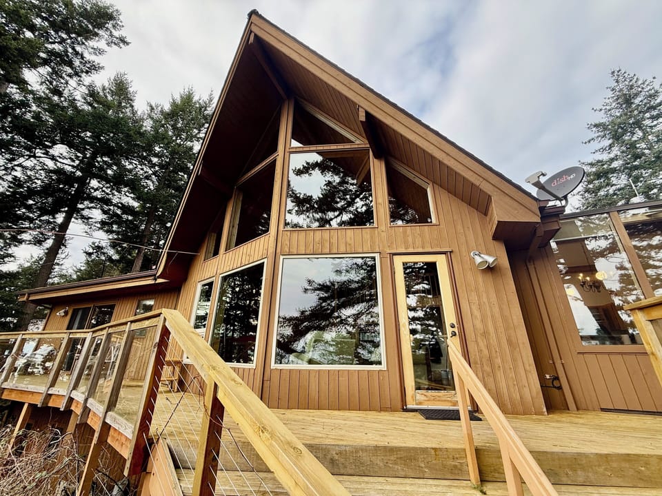 Iconic A-frame with large windows and private deck, expansive water views. 