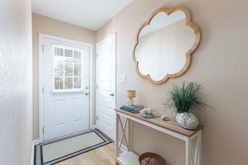 Mid Level: Bright and stylish foyer—the perfect coastal welcome to ShellSeekers Cottage