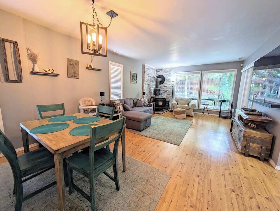 Main floor large living space with full/queen pull out sofa bed, 65" TV Equipped with Netflix, Hulu, Prime, DVD player and surround sound. Cozy wood burning fireplace and a table for 4 that is expandable to 6 with a bench.