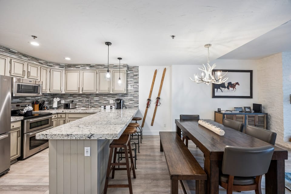 Bright and beautifully updated kitchen featuring stainless steel appliances, granite countertops, and fully stocked cookware.