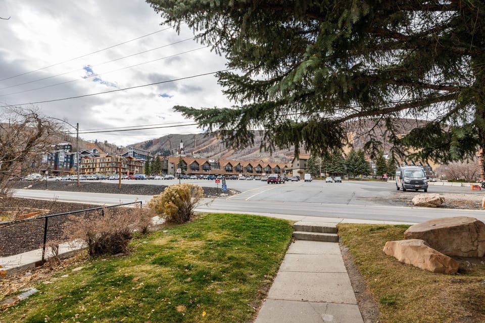 Direct access to scenic neighborhood paths with open mountain views and mature trees.