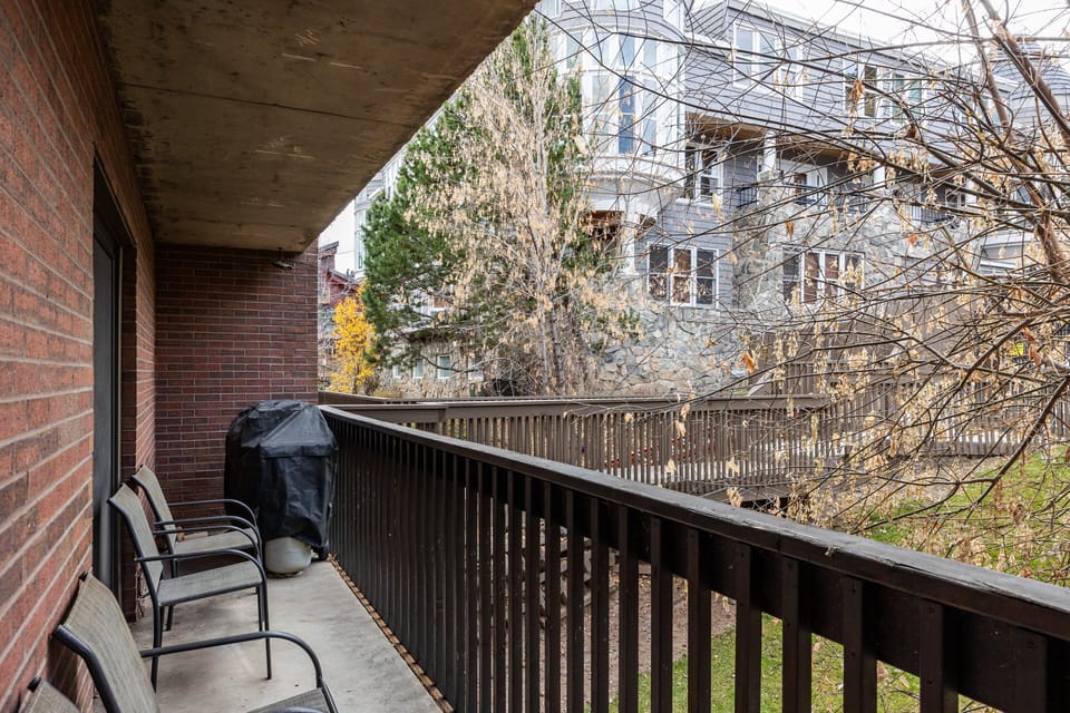 Relax on your spacious covered balcony, complete with comfortable seating and a gas grill. Overlooks a peaceful wooded setting—perfect for morning coffee or evening unwinding.