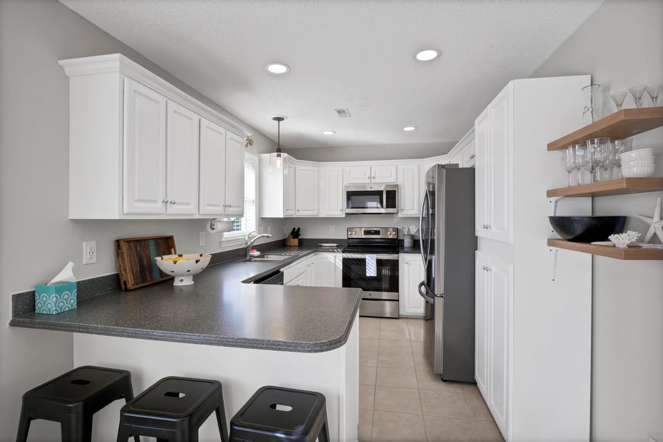 Full-service kitchen with bar stool seating 