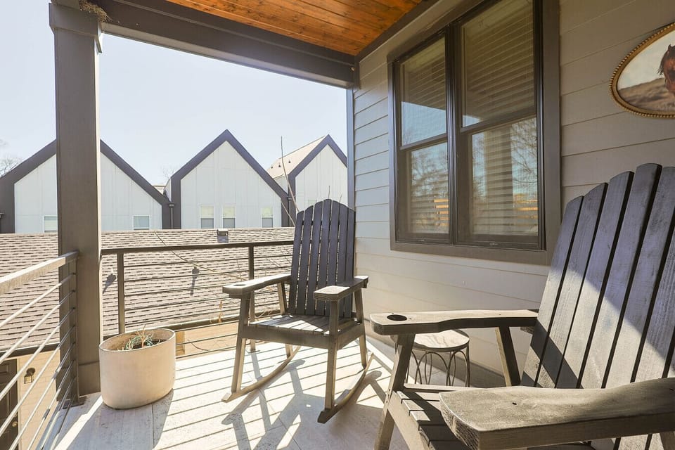 Relaxing outdoor rooftop deck featuring classic Adirondack chairs.