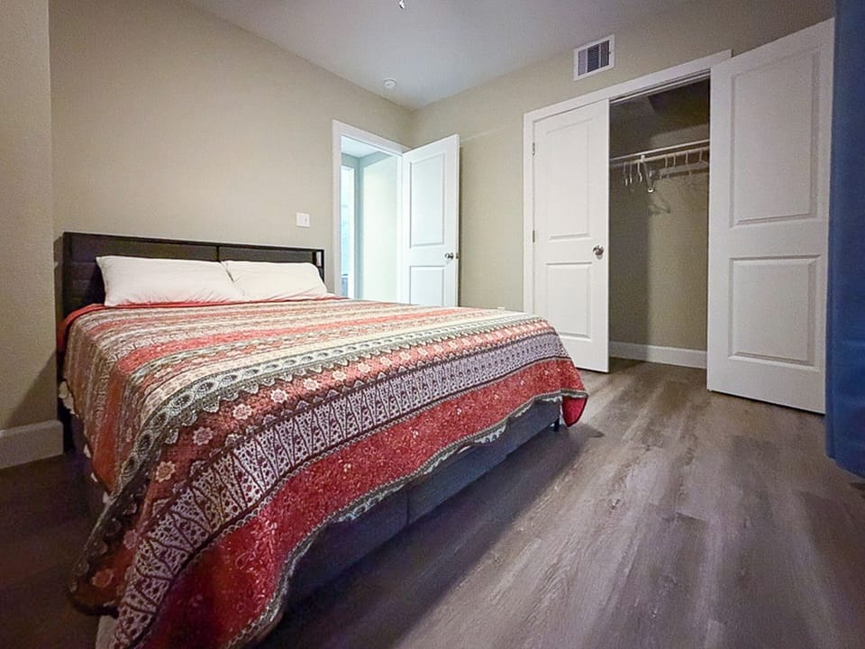 Primary bedroom with queen-sized bed and attached full-bathroom.