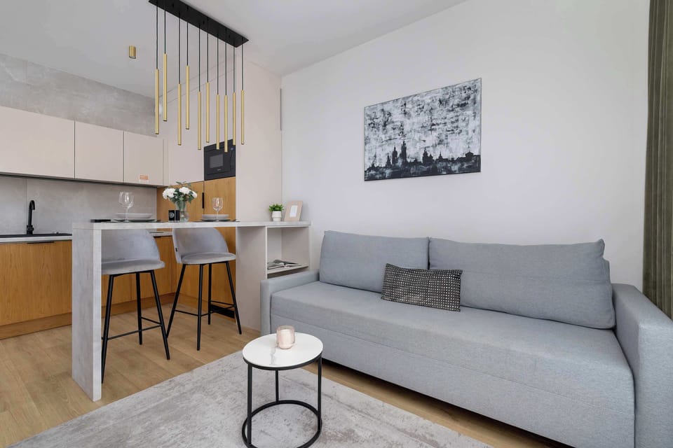 The elegant living and dining area encourages shared meals and conversations in a warm, modern setting.