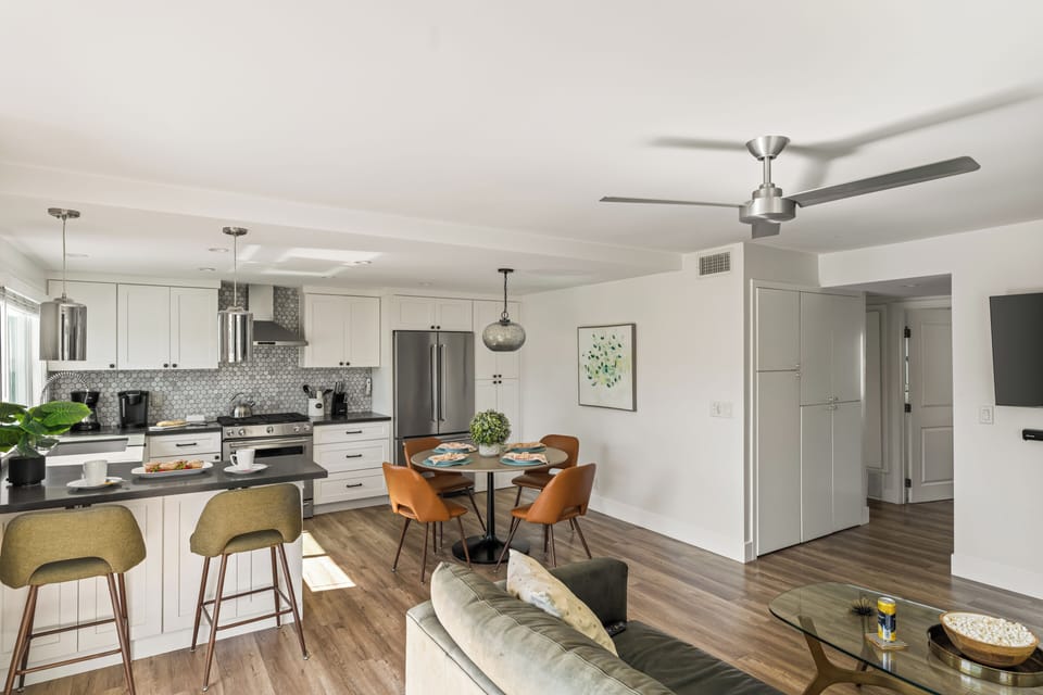 Bright open-concept kitchen and dining area designed for relaxed coastal living. (Unit 2)