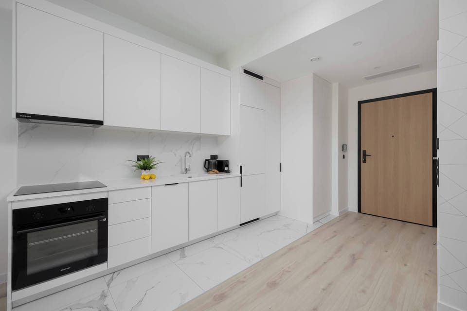 The sleek design of the kitchenette blending seamlessly with the living area.