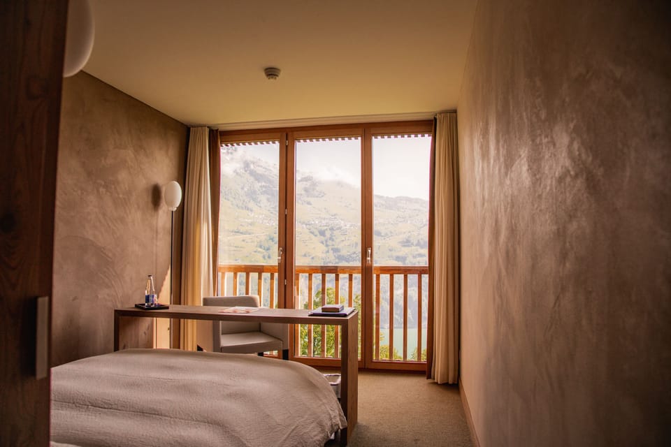 Hypo-allergenic bedding, desk, laptop workspace, blackout drapes