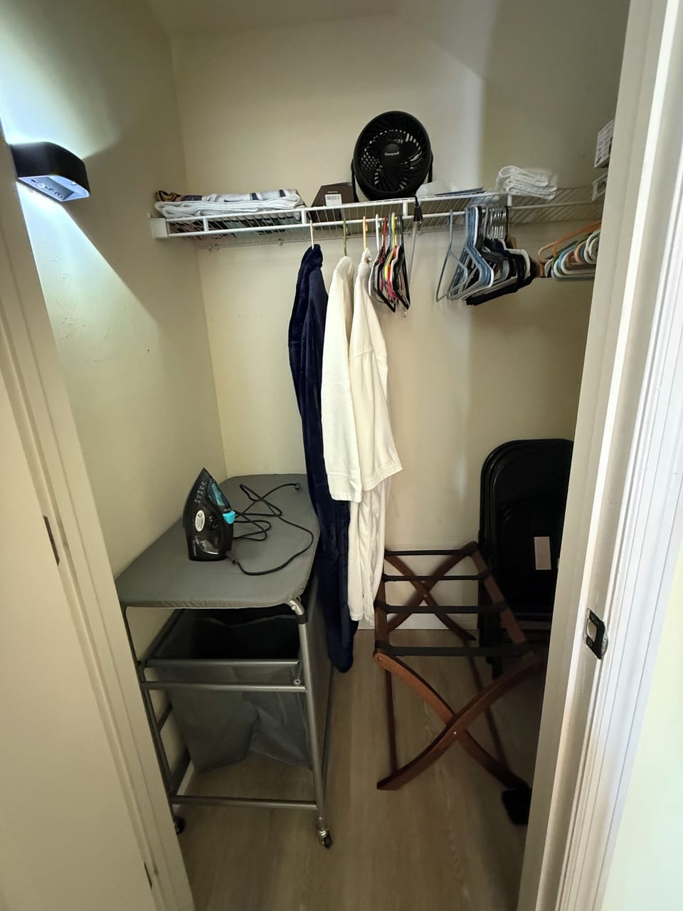 Ironing board, iron, robes , and luggage holder