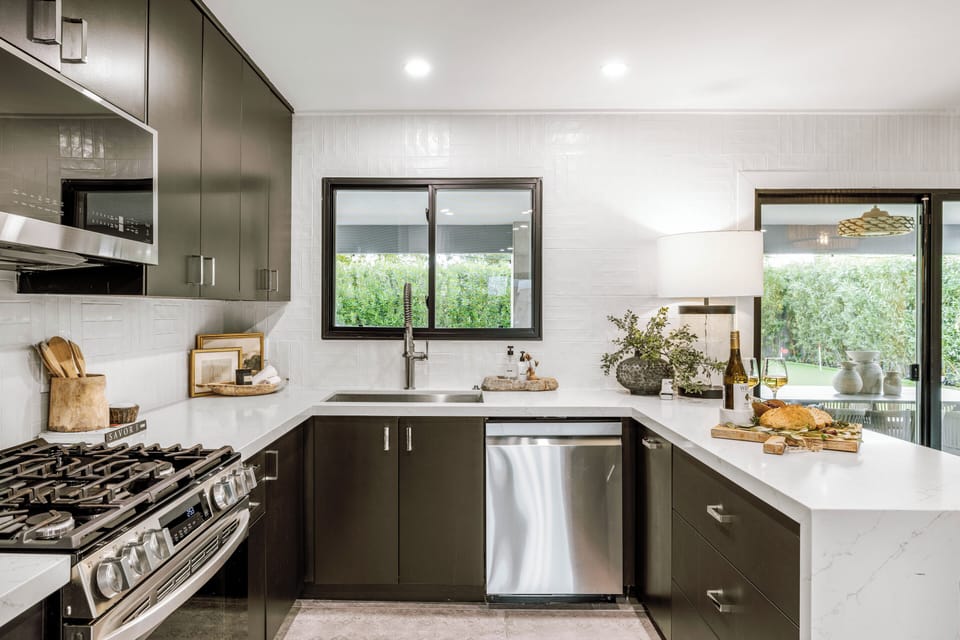 Curated décor, vintage finds, and modern appliances blend into one moody, refined space.