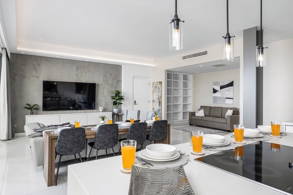 This open-concept space flows seamlessly from the sleek kitchen counter to the cozy living and dining areas, where modern finishes and warm touches create a stylish setting for relaxing or entertaining.