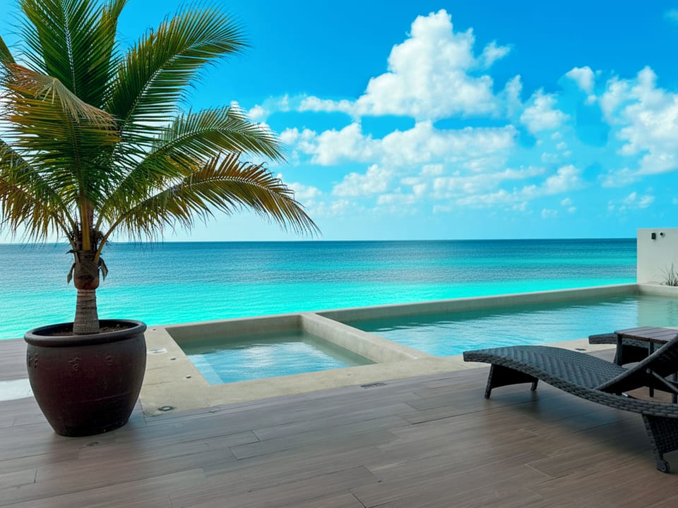 Beachfront Pool Terrace - Relax by the pool with uninterrupted ocean views just steps from the sand. With lounge chairs, tropical surroundings, and the Caribbean stretching out before you, the terrace at La Aurora is perfect for soaking up the sun and unwinding.