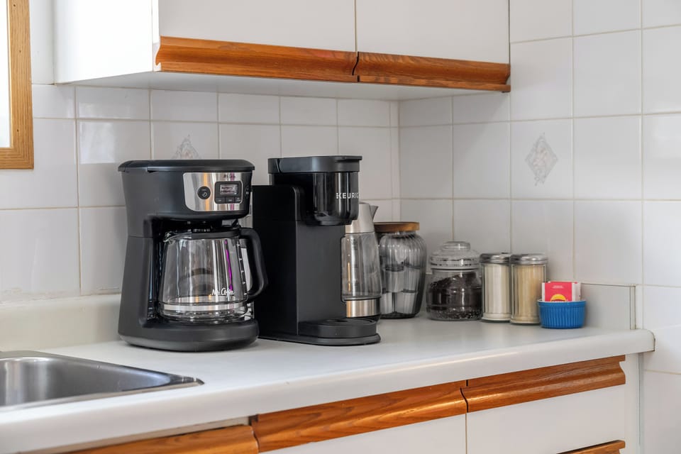 “Coffee your way: Keurig + 12-cup drip. Pods, filters, mugs, sugar & tea stocked in the upper cabinet.”