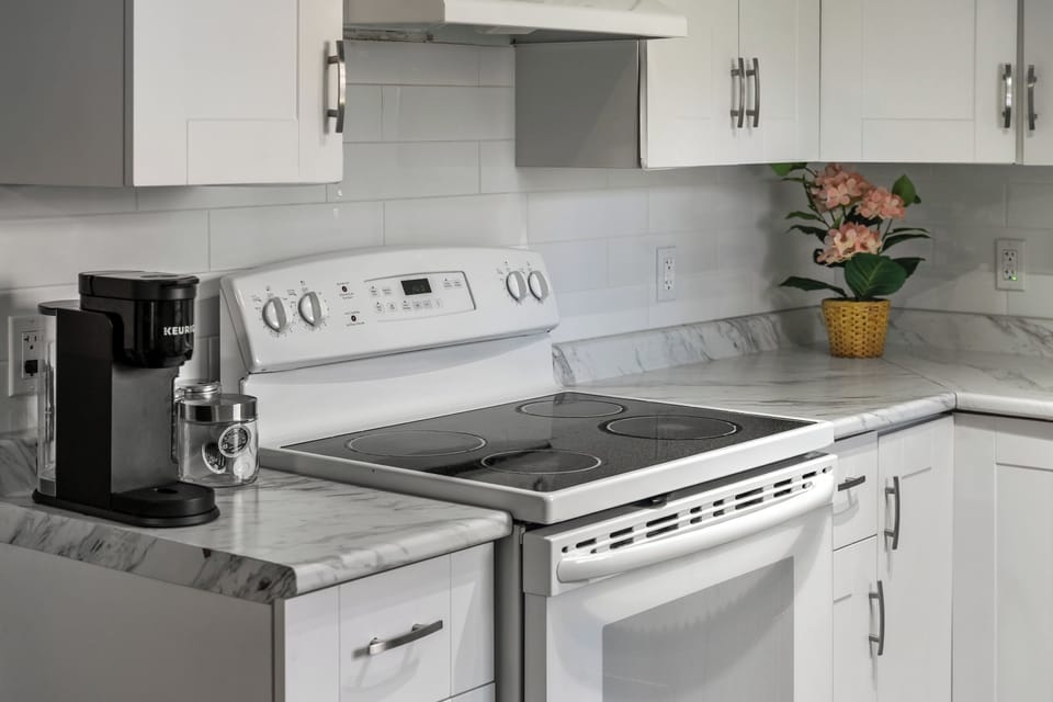 “Full kitchen with electric range/oven and all cookware meal prep made easy for weeknights or longer stays.”