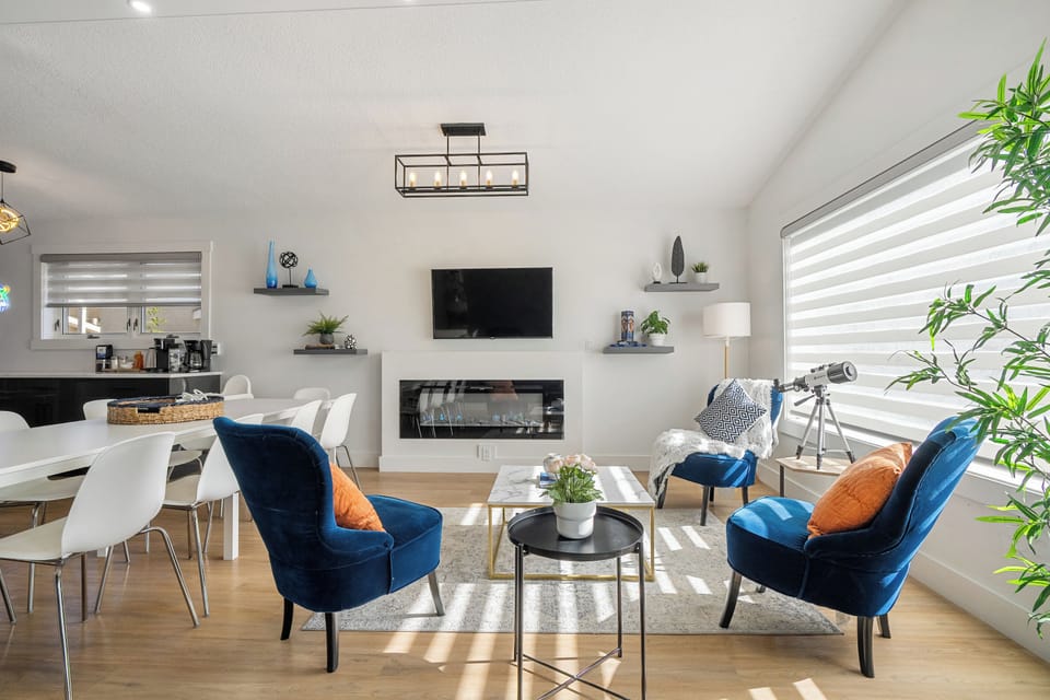 Bright living room with TV, fireplace, and comfy seating.