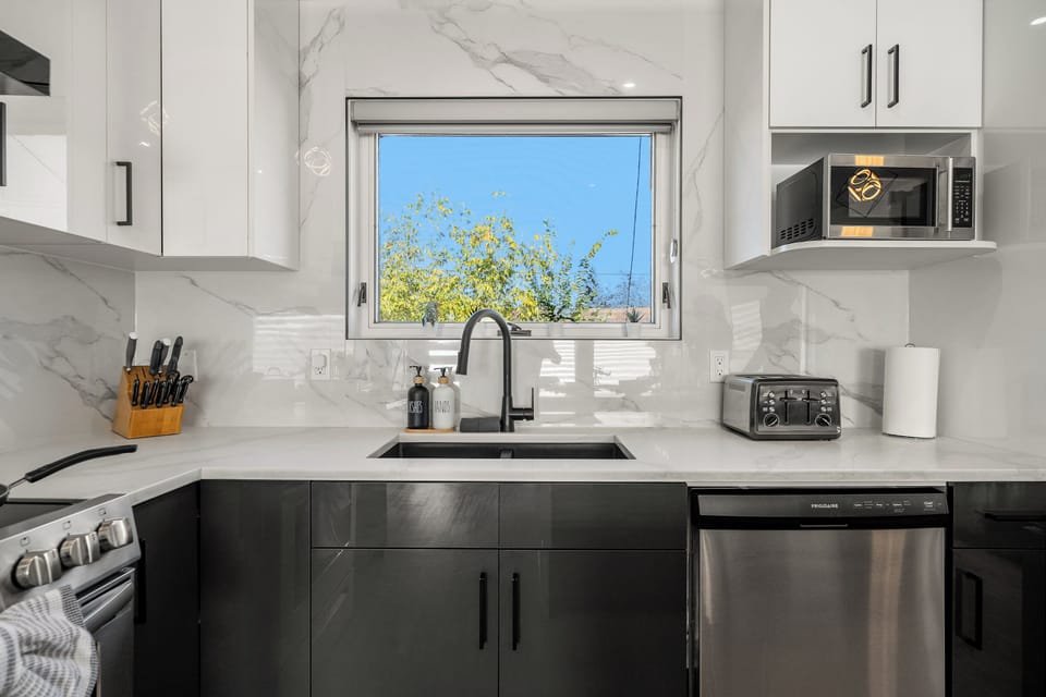 Clean sink area with window view coffee-ready and bright.