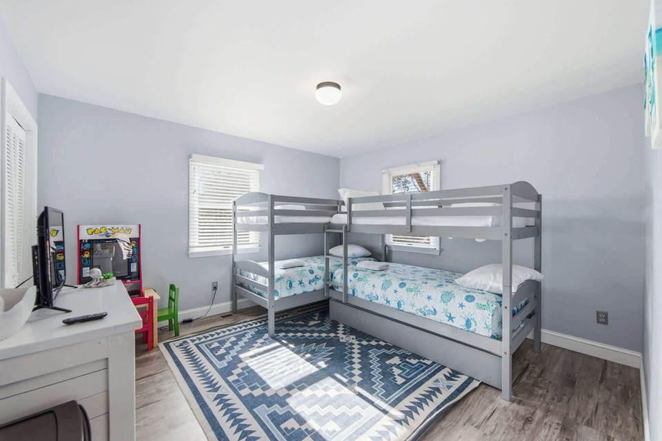 Family-friendly bunk room with two sets of twin bunk beds, offering flexible sleeping arrangements.
