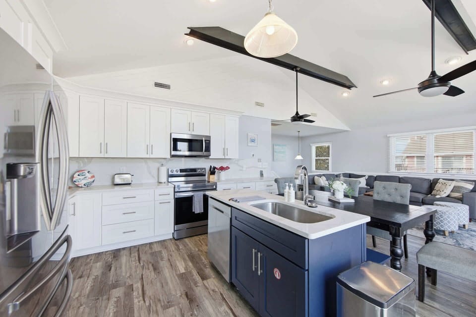 A bright, open-concept kitchen with modern finishes and full amenities - perfect for cooking, gathering, and entertaining during your vacation stay. 
