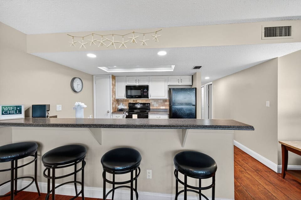 Casual breakfast bar w/ seating, great for quick bites or morning coffee.