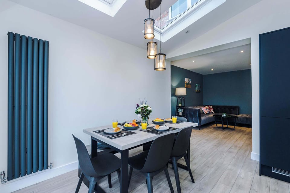 Elegant dining area with statement pendant lighting and seating for the whole group to enjoy meals together