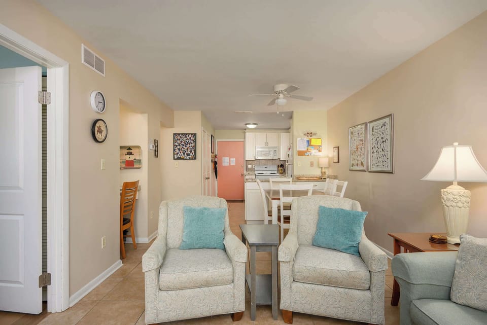 Bright, open living room with smart TV, sleeper sofa, and private patio access