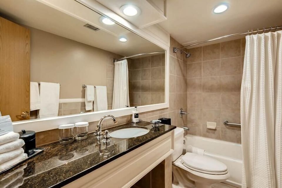 The stylish bathroom blends functionality with comfort, featuring modern amenities and thoughtful touches for a family-friendly retreat.
