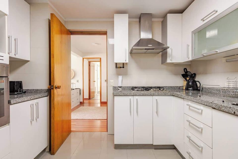 Sleek and modern kitchen with ample counter space and natural light, perfect for culinary adventures.