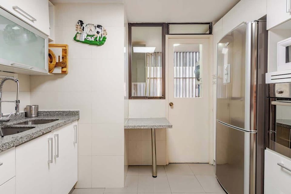 Bright and modern kitchen with sleek appliances and ample counter space, perfect for home-cooked meals.