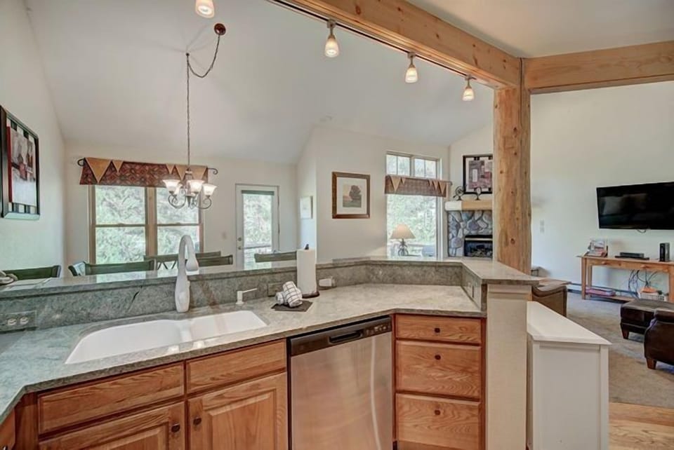 Bathe in natural light as you entertain in this spacious living area, where the kitchen flows seamlessly into the heart of the home.