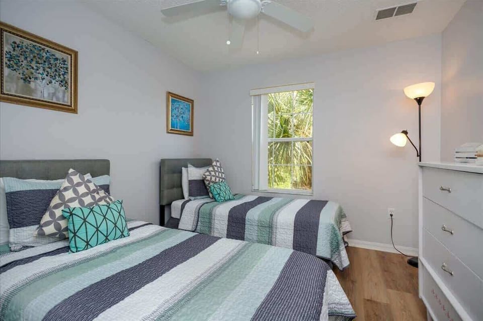 Upper Level | Twin Bedroom | Comfortable & Modern
This cheerful guest room features two matching twin beds, fresh striped linens, and thoughtful decor for a restful stay.