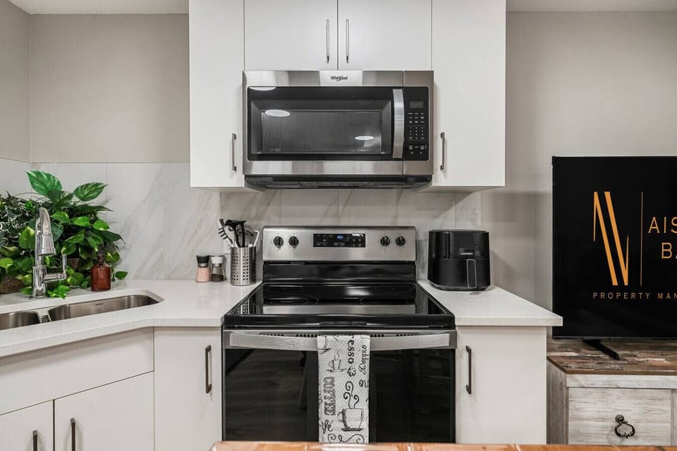 Full kitchen with a drip coffee maker, ground coffee, tea, sugar, and basic condiments (ketchup, mustard & relish.)