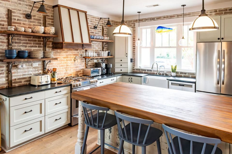 A standout feature of this family-friendly Morehead City retreat, the kitchen combines elevated style with practical touches like a coffee station and inviting island seating.