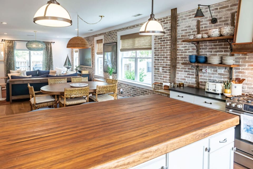 This stylish, spacious kitchen features high-end finishes, a dedicated coffee bar, and island seating—perfect for gathering in this luxury Morehead City vacation rental.