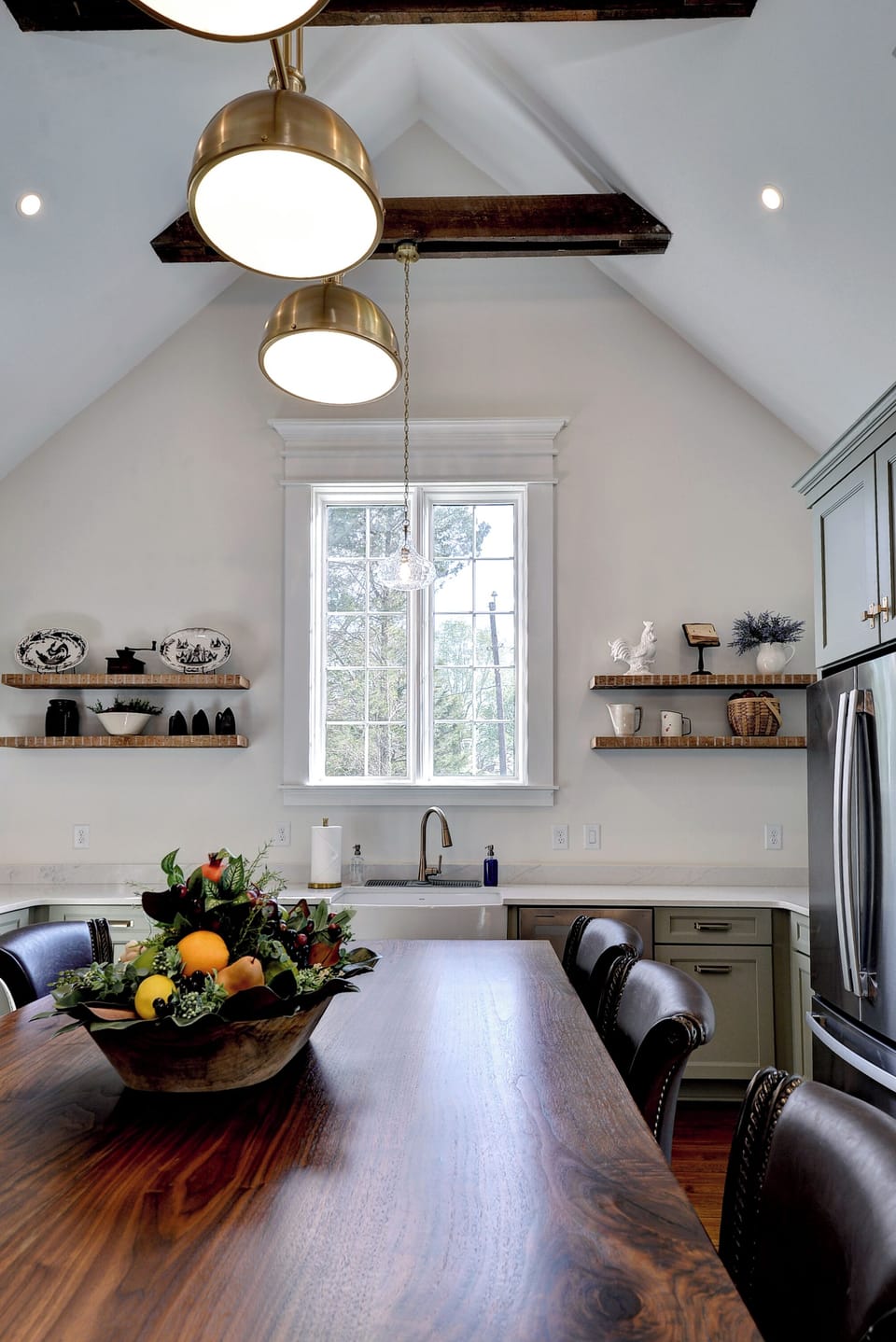 Airy vaulted kitchen with walnut island, brass lights & open shelves