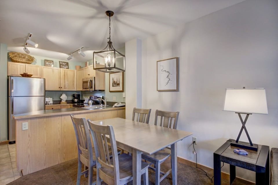 Fully equipped kitchen with stainless steel appliances and rich wood accents offering a stylish mix of rustic and modern design.