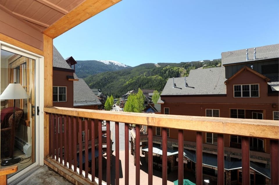 Private balcony with views of the village and surrounding mountains, perfect for relaxing with morning coffee or evening drinks.