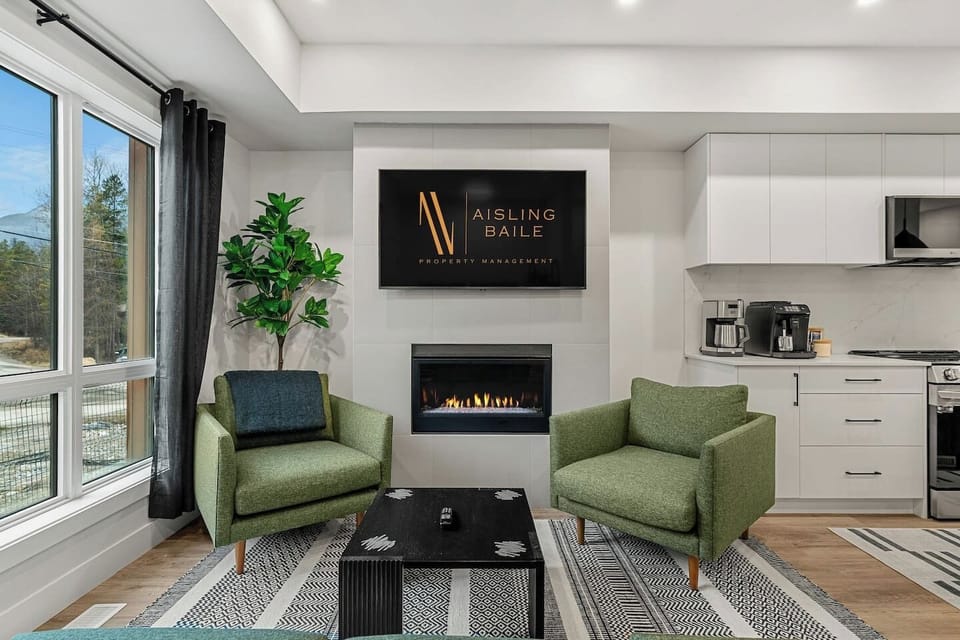 Living room, located on the main floor, with cozy seating options, a gas-lit fireplace and board games.