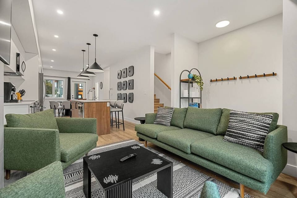 Living room, located on the main floor, with cozy seating options, a gas-lit fireplace and board games.