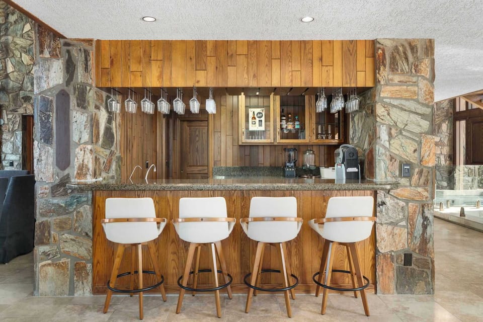 Main salon bar with seating, sink, icemaker and multiple refrigerators