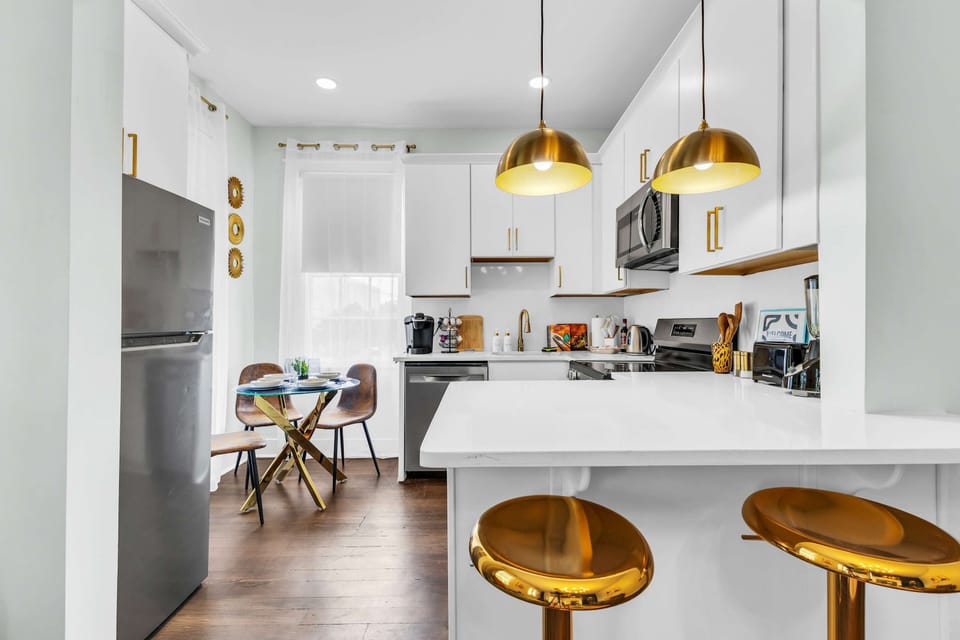 COOK & CREATE! Fully equipped modern kitchen with stainless steel appliances. Turn family meals into vacation feasts! Gold accents throughout. Book your Savannah stay! #ModernKitchen #FamilyFriendly