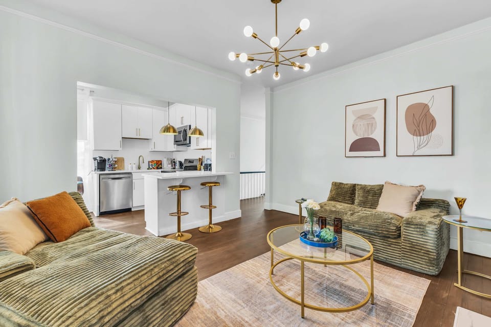 COMFORT ZONE: Ribbed olive green sofa with modern styling. Turn family time into vacation bliss! Perfect for families exploring Savannah. Reserve today! #FamilyFriendly #SavannahStay