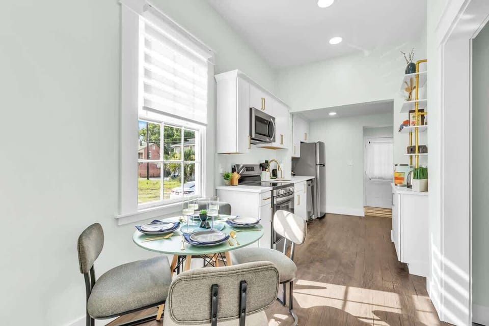 DINE & CELEBRATE! Elegant dining room for family meals. Turn dinner time into vacation traditions! Modern table, comfortable seating. Book now! #FamilyDining #SavannahCharm