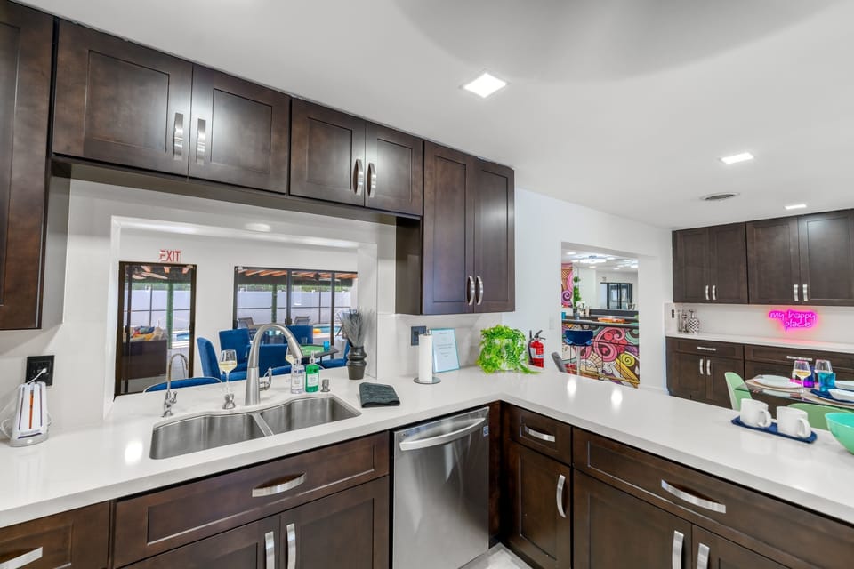 COOK TOGETHER FAMILY FUN! Fully-equipped kitchen with modern appliances with a  pass-through window, overlooking the  pool . Perfect for families who love homemade meals. #Familyfriendlyairbnb #Largehomeairbnb 