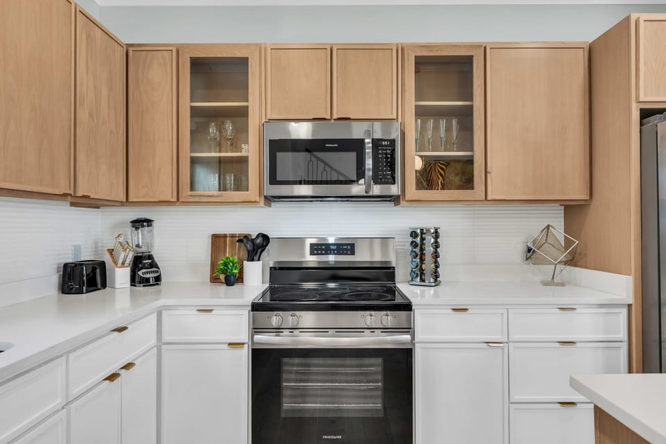 GOURMET KITCHEN: Fully stocked with modern appliances & gold accents! Turn family meals into vacation delight! Island seating, Keurig, dishwasher. Book your Savannah stay! #GourmetKitchen #FamilyMeals